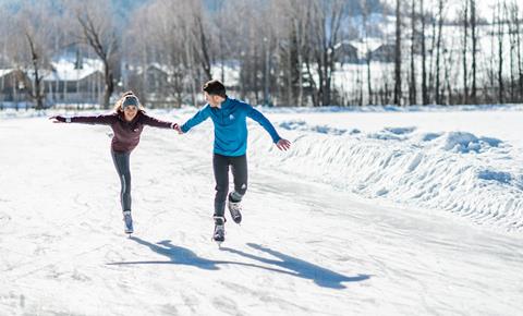 A couple is ice skating